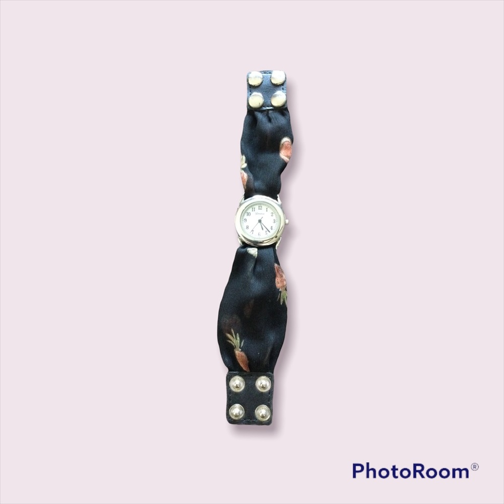 Silver watch face with black fabric band with double snap closure